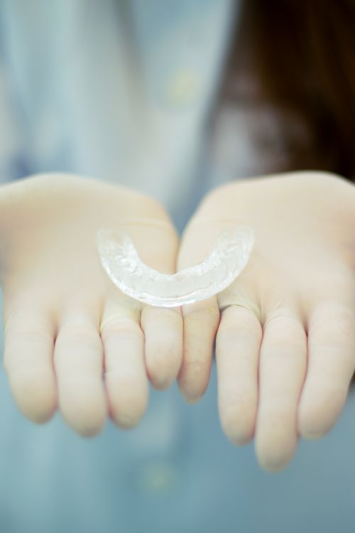 Clear Aligner Thermoforming Production — Dental Lab Fabrication Process Dental aligner tray thermoforming production process — vacuum-formed from thermoplastic sheet over 3D printed dental model